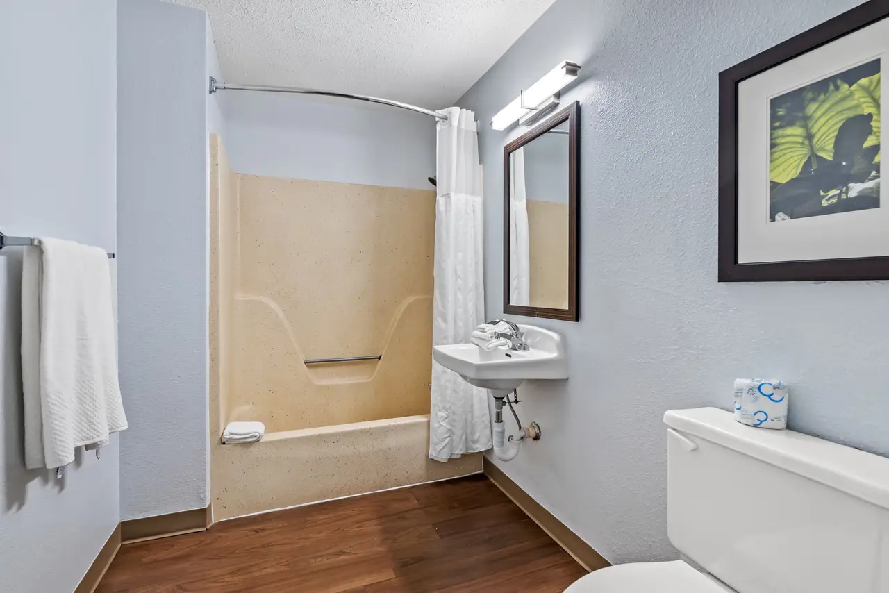 Accessible bathroom with bathtub grab bar and open sink space